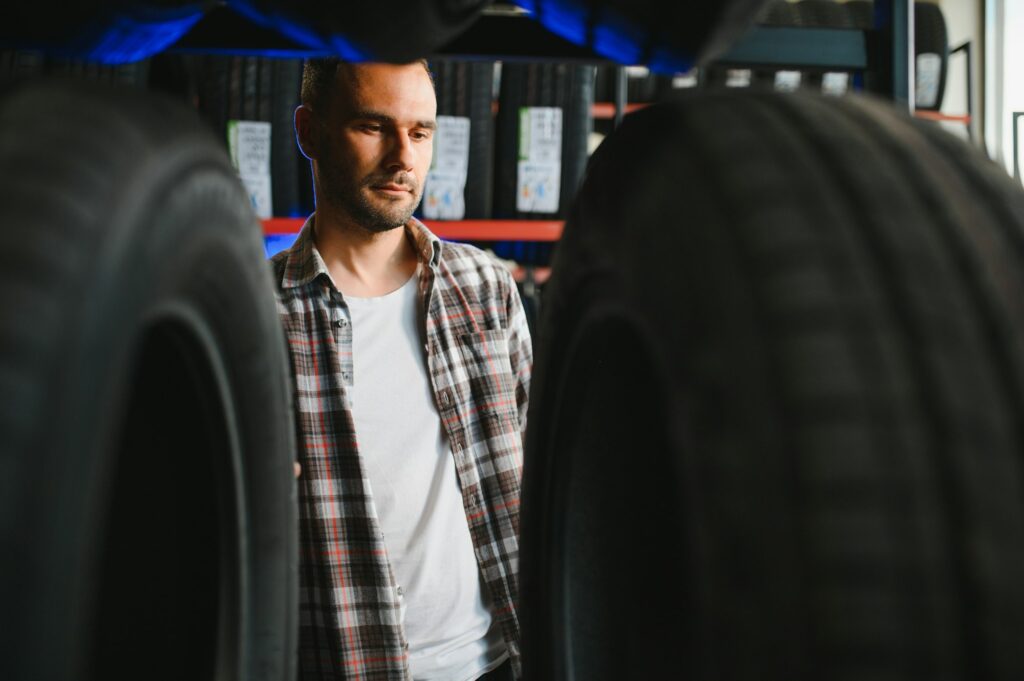A male customer in a car tire shop