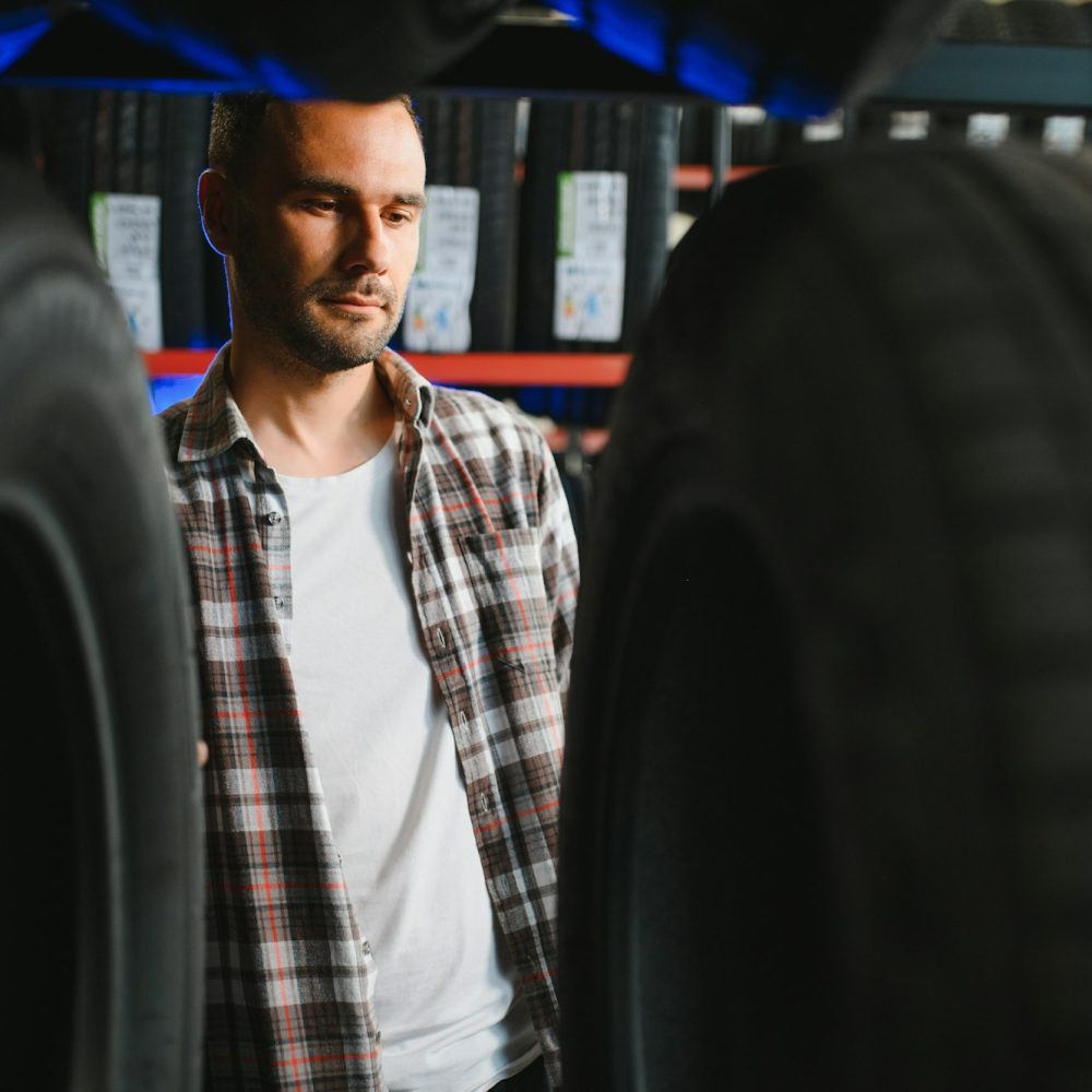 A male customer in a car tire shop
